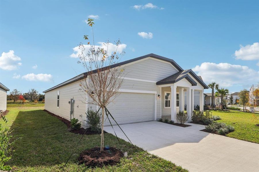 Front exterior of a new home in Ellington Traditional, St. Cloud, FL, highlighting curb appeal (Image 20). Front exterior of a new home in Ellington Traditional, St. Cloud, FL, highlighting curb appeal (Image 20).