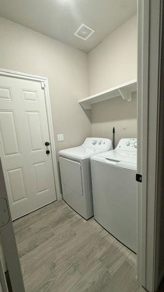 Utility room with door to backyard.