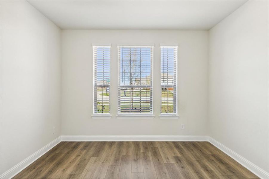 Unfurnished room with dark hardwood / wood-style floors and a wealth of natural light