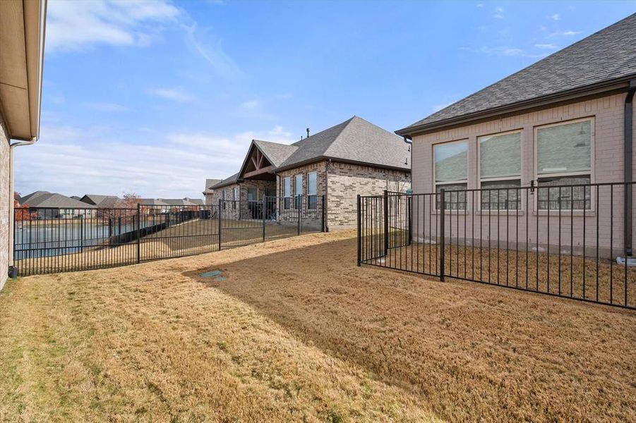 Back of the home offers views of the pond, pickleball courts and clubhouse.   Very easy walk to where all of the activities are!