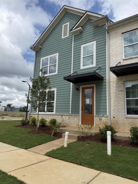 Contemporary exterior with light green horizontal siding and white brick accents Contemporary exterior with light green horizontal siding and white brick accents