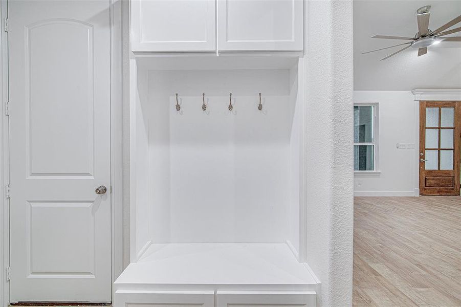 Mudroom featuring a ceiling fan, wood finished floors, and baseboards Mudroom featuring a ceiling fan, wood finished floors, and baseboards