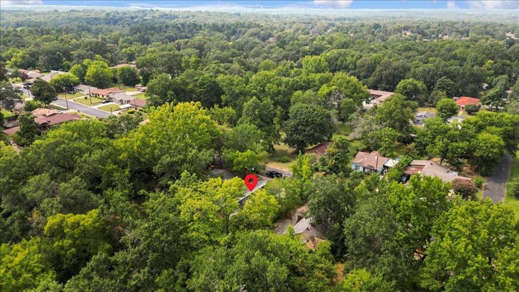 View of property location with a forest and nearby suburban area