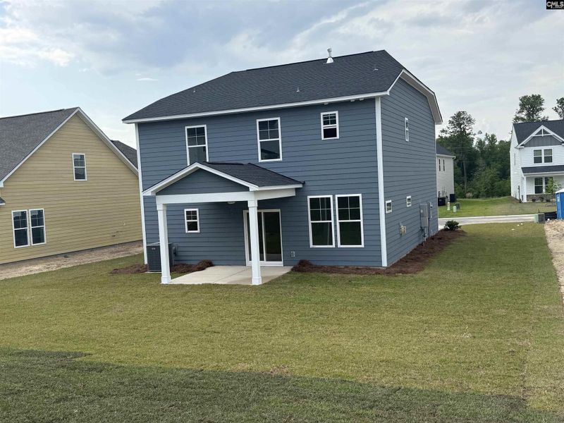 Exterior details and patio area of a home in Cottages at Roofs Pond, West Columbia (Image 3).