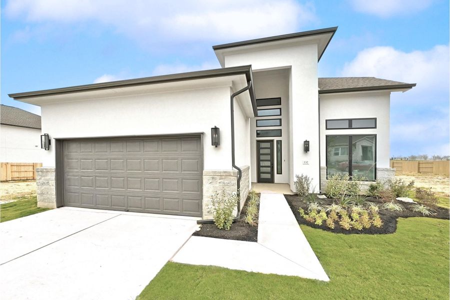Front exterior of a new home in The Colony, Bastrop, TX, highlighting curb appeal (Image 25).