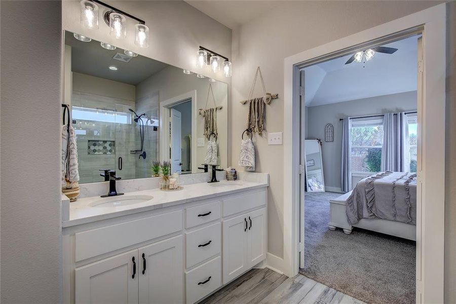 Bathroom with walk in shower, hardwood / wood-style floors, vanity, and ceiling fan