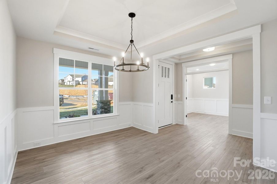 Dining room with tray ceiling & wainscoting