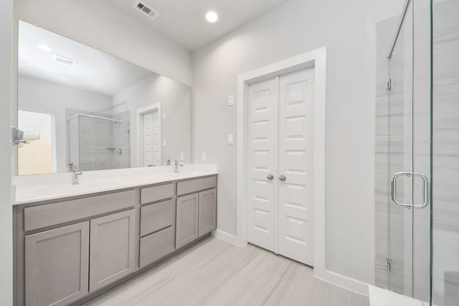 Indulge in a spa-like retreat within the confines of this primary bathroom. Delight in a spacious walk-in shower enveloped in stylish tile surround and unwind in a separate garden tub adorned with custom detailing. Indulge in a spa-like retreat within the confines of this primary bathroom. Delight in a spacious walk-in shower enveloped in stylish tile surround and unwind in a separate garden tub adorned with custom detailing.