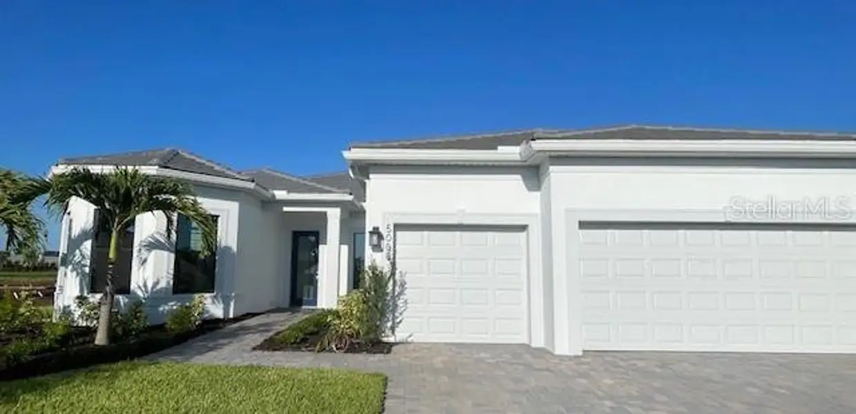 Front exterior of a new home in Del Webb Catalina, Lakewood Ranch, FL, highlighting curb appeal (Image 2).