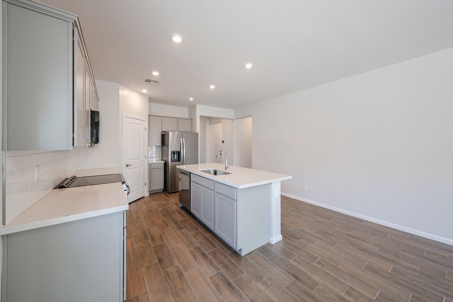 A kitchen with white cabinets.
