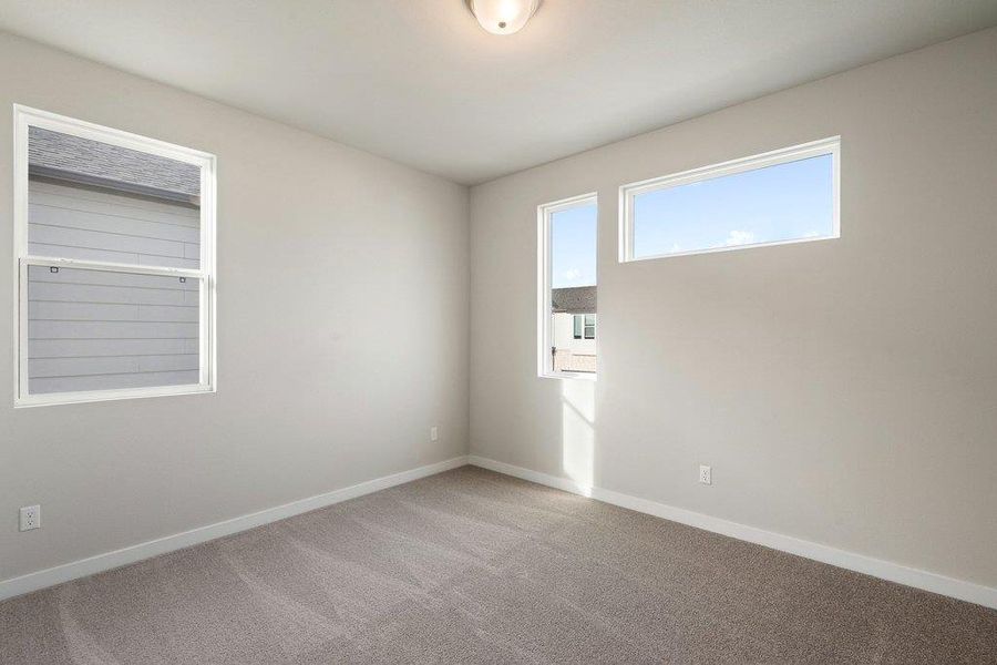 Empty room featuring baseboards and carpet
