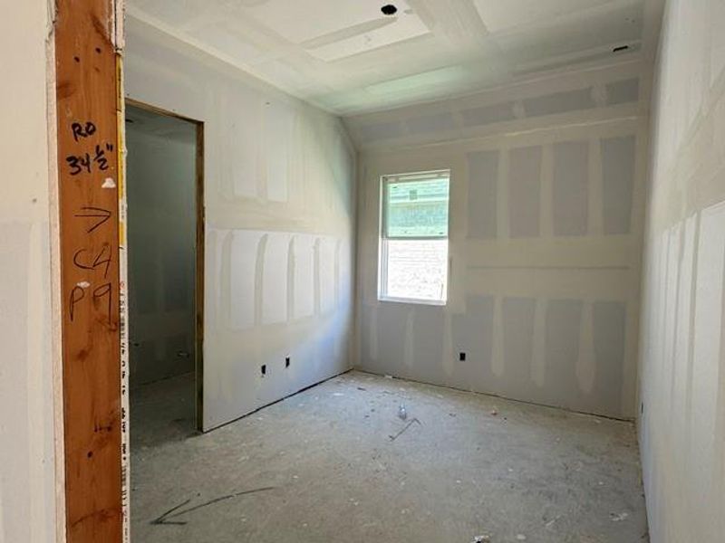 A promising interior space awaits customization, featuring fresh drywall and a window for natural light. A promising interior space awaits customization, featuring fresh drywall and a window for natural light.