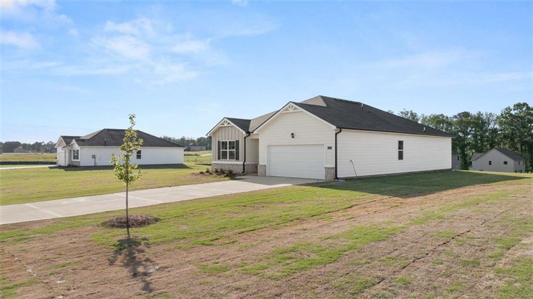 Front exterior of a new home in Champion's Run, Lithonia, GA, highlighting curb appeal (Image 29).