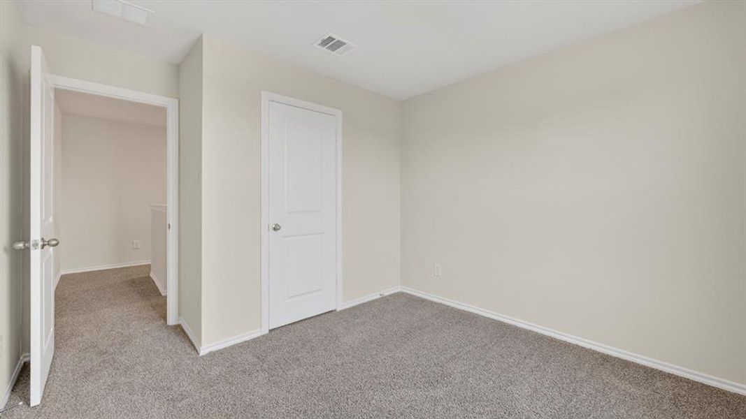 Carpeted room with light-colored walls and white trim