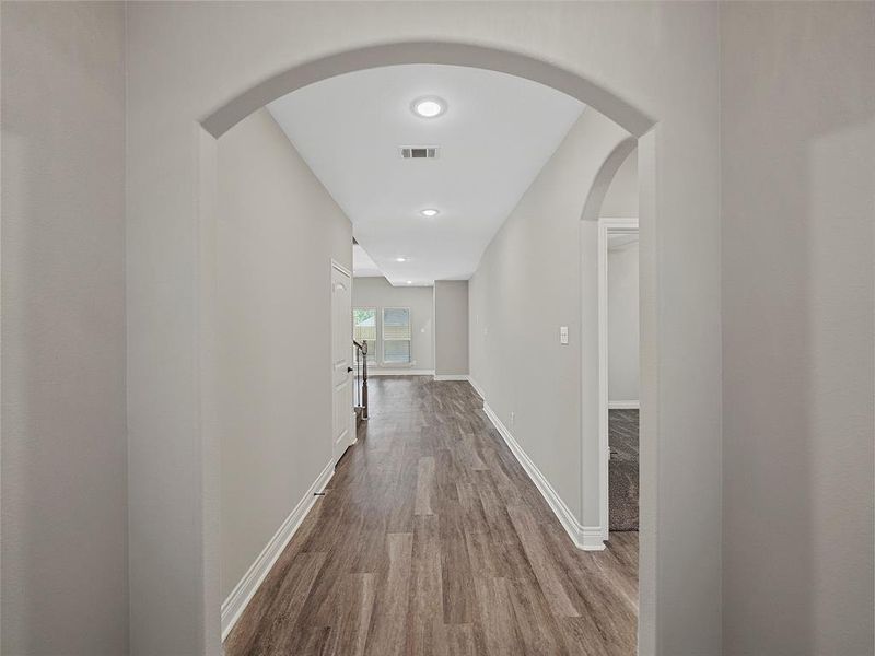 Corridor with wood finished floors and arched walkways Corridor with wood finished floors and arched walkways