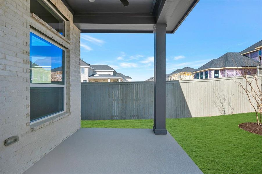 Fenced backyard with a patio area and a residential view