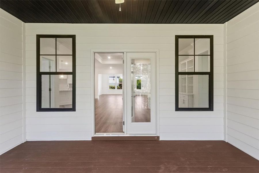 A covered back porch offers crisp horizontal sidin