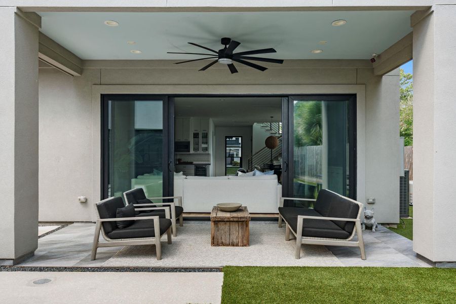 The covered outdoor patio extends directly off of the family room through large sliding glass doors, creating seamless indoor outdoor living. With the ceiling fan, recessed lighting, and plenty of space for outdoor seating, this area is ideal for entertaining, relaxing, or enjoying the turfed backyard year round.