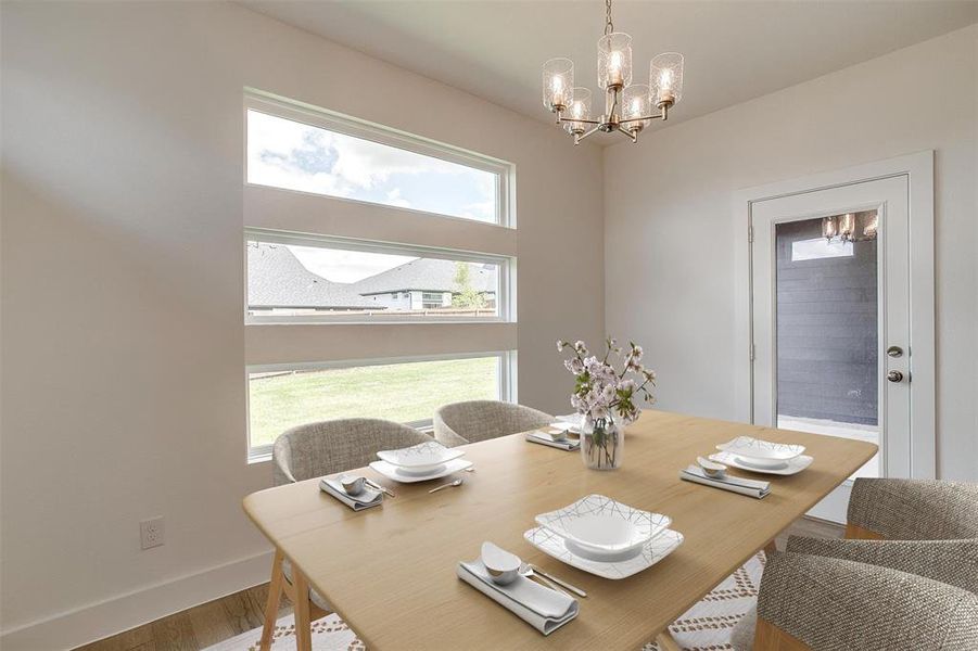 Dining room with a notable chandelier and hardwood / wood-style floors