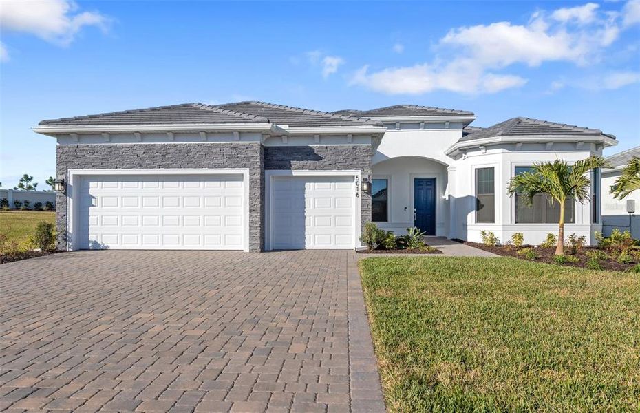 Front exterior of a new home in Del Webb Catalina, Lakewood Ranch, FL, highlighting curb appeal (Image 21).