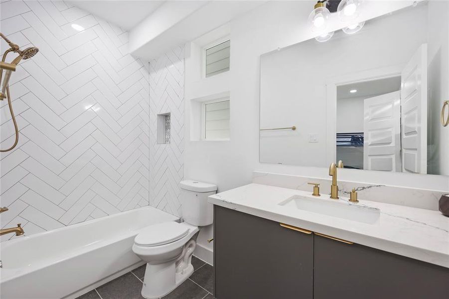 This beautiful second ensuite bath with neutral tones features gorgeous finishes and a fully tiled bath.