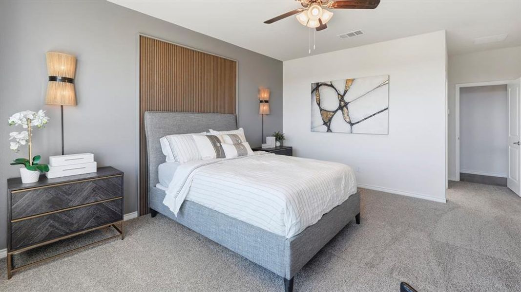 Bedroom with a ceiling fan and carpet flooring