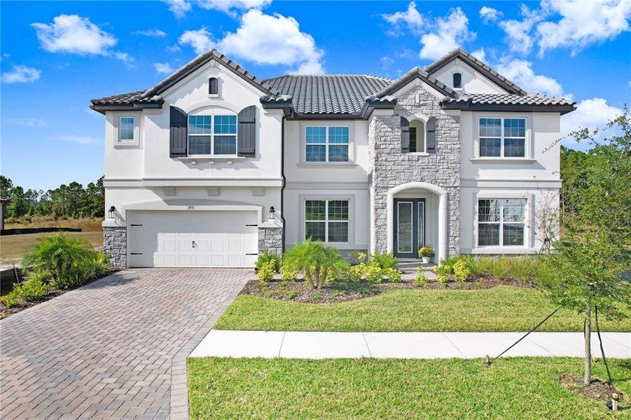 Front exterior of a new home in Shortgrass at Two Rivers, Zephyrhills, FL, highlighting curb appeal (Image 2). Front exterior of a new home in Shortgrass at Two Rivers, Zephyrhills, FL, highlighting curb appeal (Image 2).