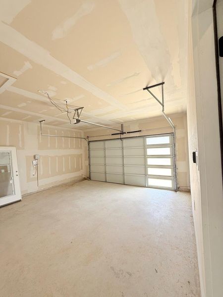 A spacious, newly finished garage offers ample parking and storage potential.  Includes outlet prewired for EV