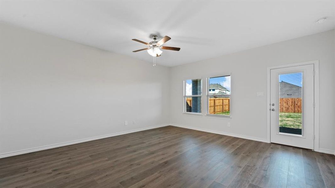 Empty room featuring dark wood finished floors and ceiling fan Empty room featuring dark wood finished floors and ceiling fan