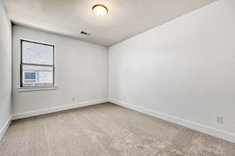 Unfurnished room featuring baseboards and light colored carpet