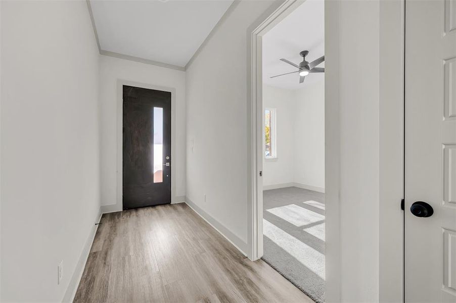 Foyer entrance featuring light wood-style flooring and ceiling fan