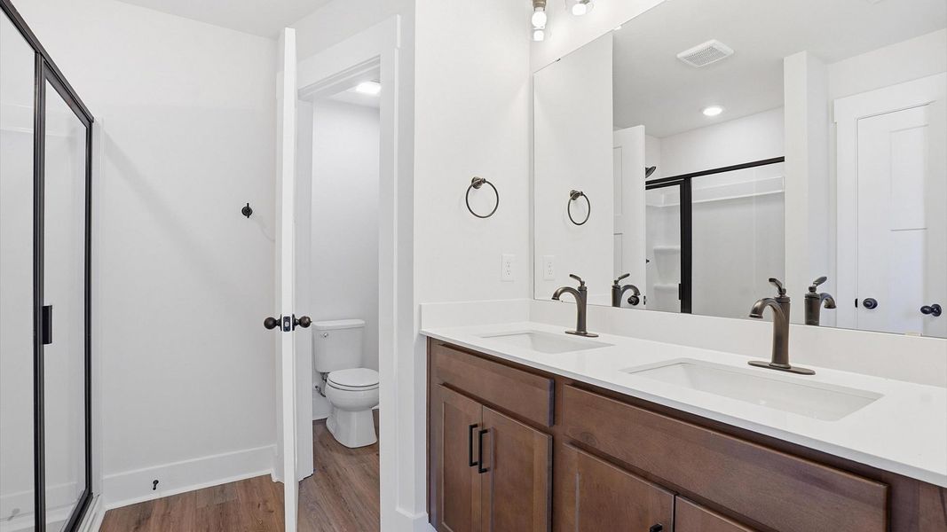 Highly functional and elegant en-suite with dual vanities, tiled walk-in shower, and refined finishes at Marion Square Highly functional and elegant en-suite with dual vanities, tiled walk-in shower, and refined finishes at Marion Square