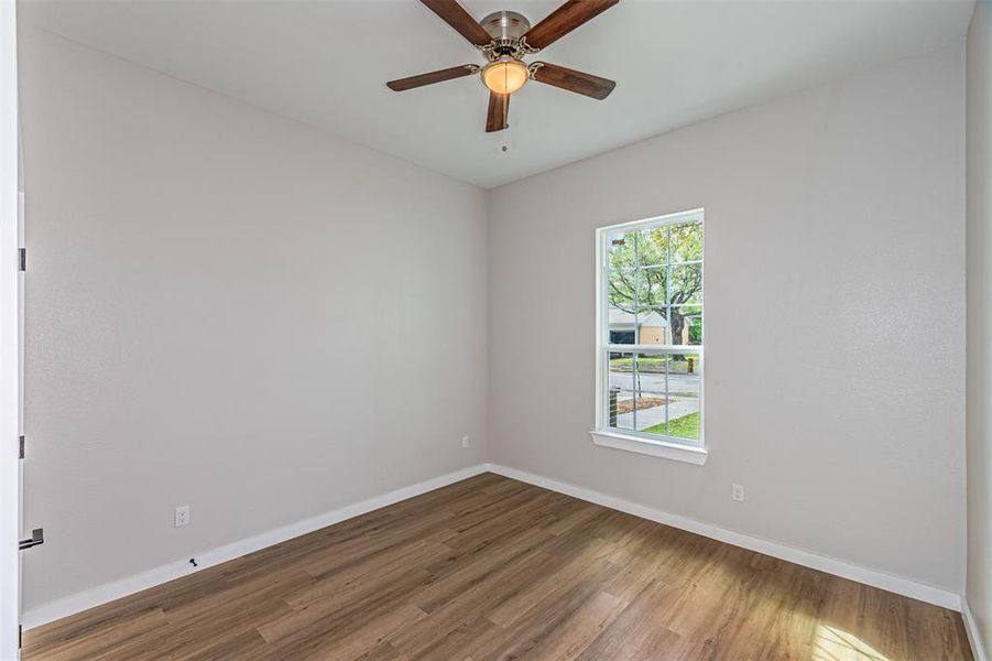 Unfurnished room with light wood-type flooring and ceiling fan