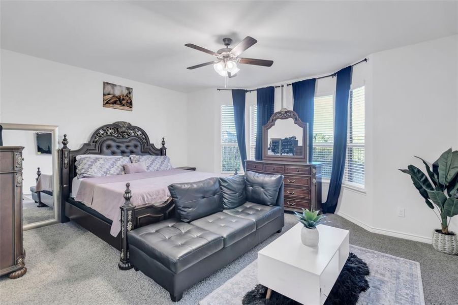 Bedroom featuring ceiling fan and light carpet