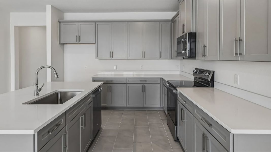 Longleaf Floor Plan Kitchen and Stunning Island by DRB Homes Lakeside at Satilla in New Homes St. Cloud