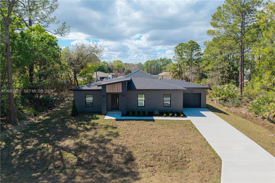 Front exterior of a new home in , Palm Bay, FL, highlighting curb appeal (Image 28).