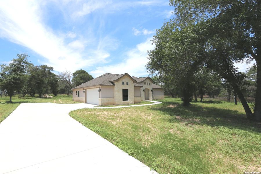 Front exterior of a new home in , Floresville, TX, highlighting curb appeal (Image 29).