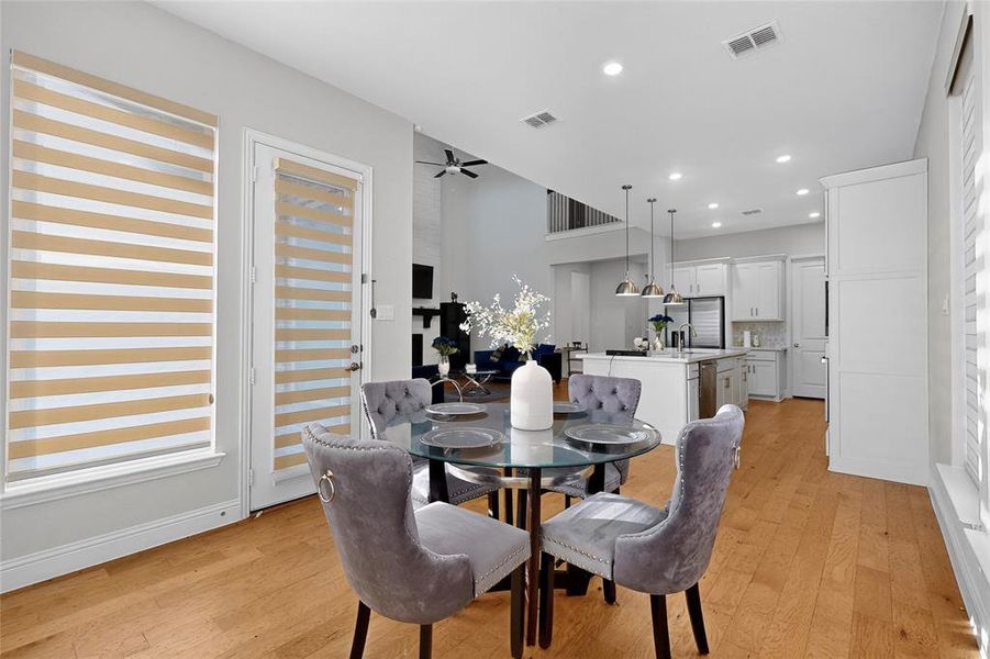 Dining room with light wood-style floors, recessed lighting, and a ceiling fan