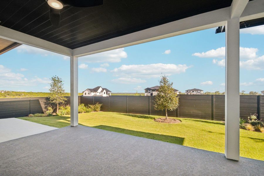 Exterior details and patio area of a home in Milky Way at River Place, Austin (Image 19).