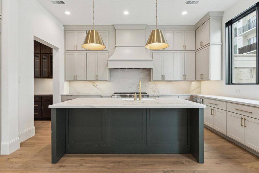 Kitchen features custom Benedettini cabinetry throughout, including upgraded decorative hood in the Venetian style.