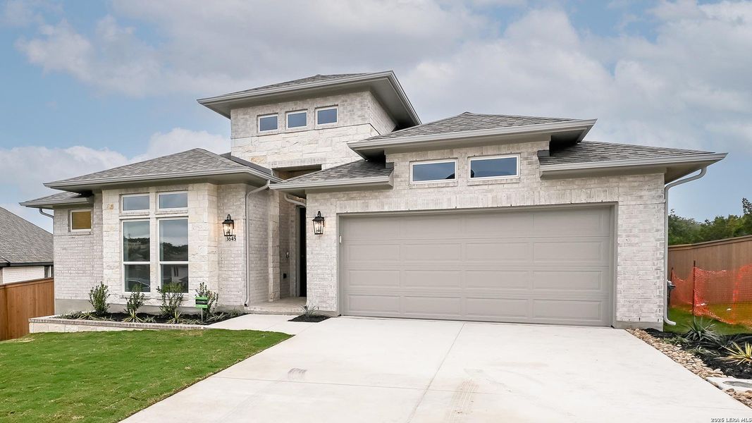 Front exterior of a new home in Johnson Ranch 55', Bulverde, TX, highlighting curb appeal (Image 22).
