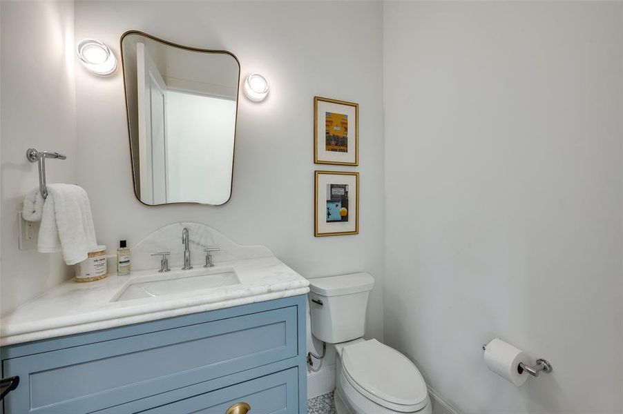 Bathroom featuring toilet and vanity Bathroom featuring toilet and vanity