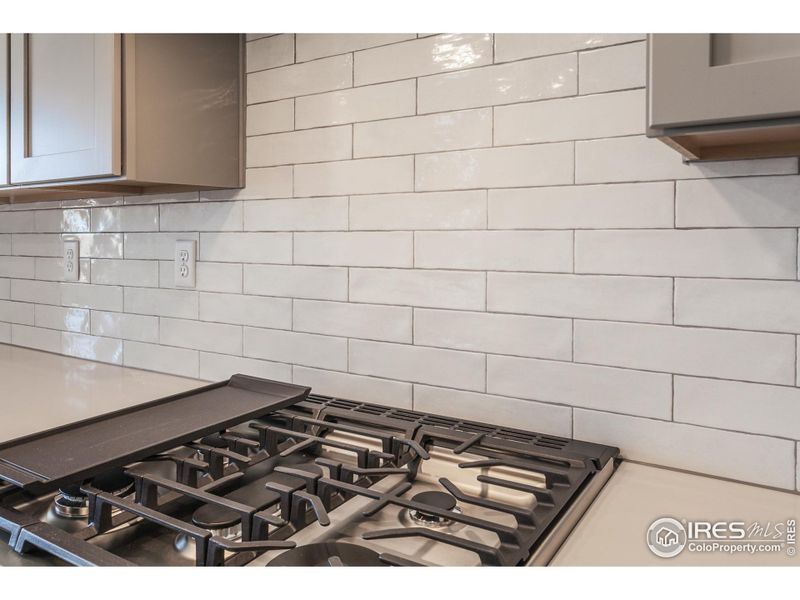 Photos of previously built home. This home features an induction range.