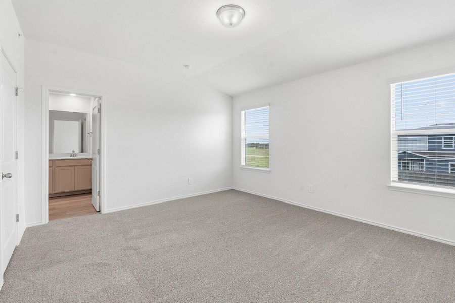 Spacious room featuring neutral carpeting and white walls Spacious room featuring neutral carpeting and white walls