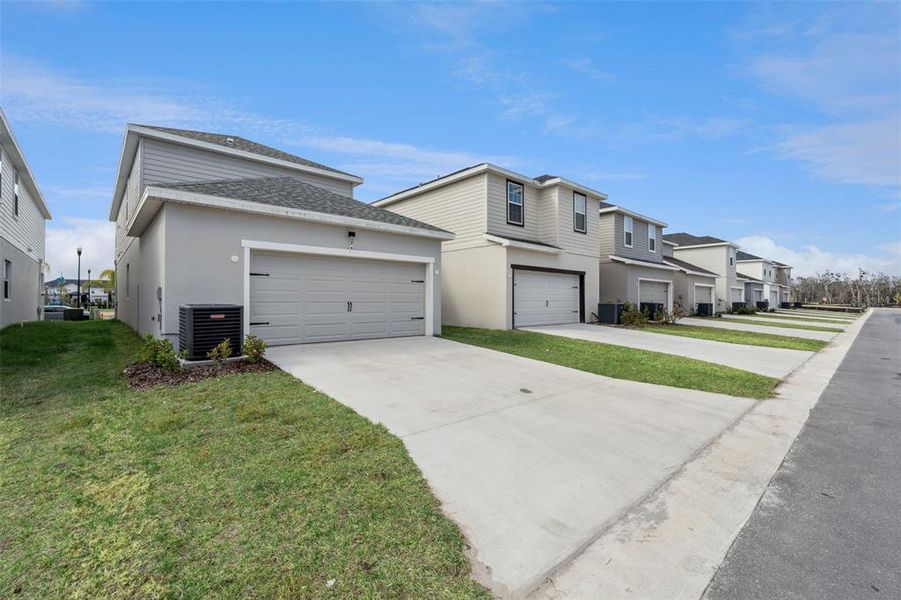 Front exterior of a new home in , St. Cloud, FL, highlighting curb appeal (Image 27).