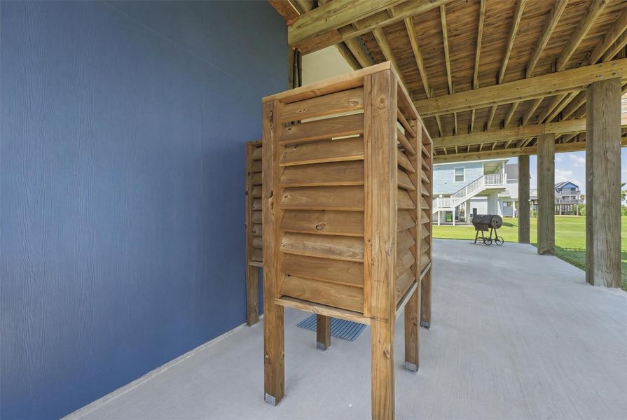 Spacious covered patio area with outdoor shower, perfect for rinsing off after enjoying the nearby beach. Spacious covered patio area with outdoor shower, perfect for rinsing off after enjoying the nearby beach.