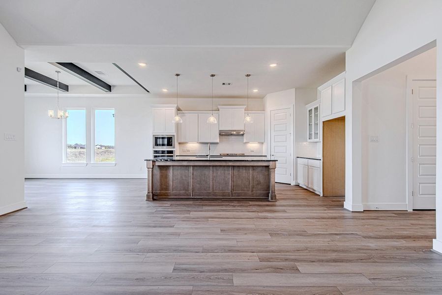 Wide-angle view of open-concept living and kitchen layout.