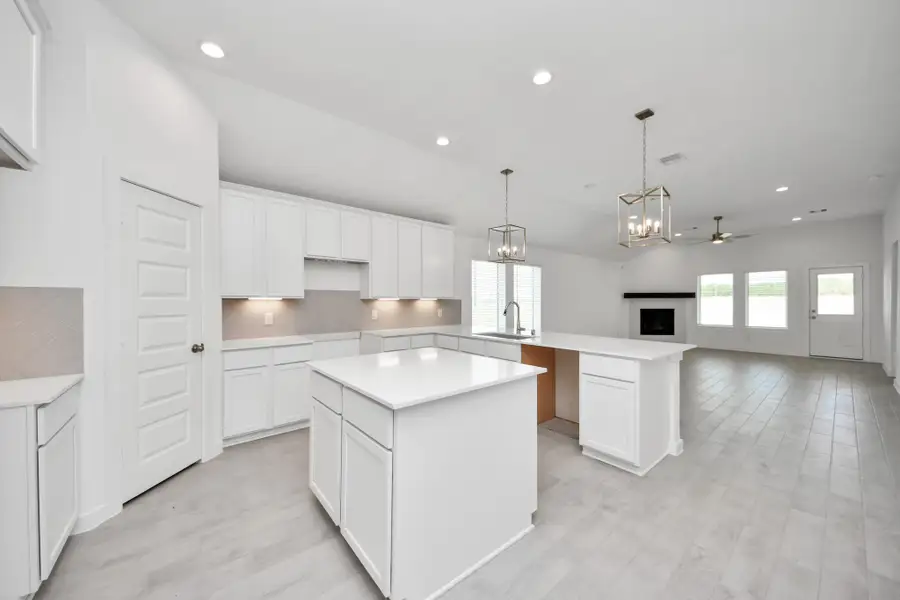 This kitchen is by far any chef’s dream! This spacious kitchen features high ceilings, light stained wood cabinets, granite countertop, SS appliances, modern tile backsplash, recessed lighting, extended counter space, granite kitchen island with double sink, and space for breakfast bar, and a walk-in pantry all overlooking your huge family room. Sample photo of completed home with similar floor plan. Actual colors and selections may vary.