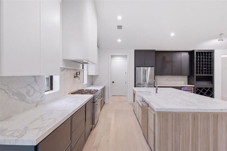 Featuring abundant prep space and designer touches throughout, this oversized kitchen island creates the ultimate entertaining space.