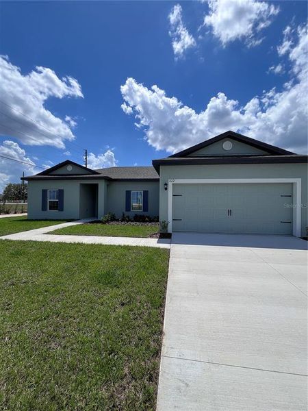 Front exterior of a new home in Citrus Place, Babson Park, FL, highlighting curb appeal (Image 1). Front exterior of a new home in Citrus Place, Babson Park, FL, highlighting curb appeal (Image 1).